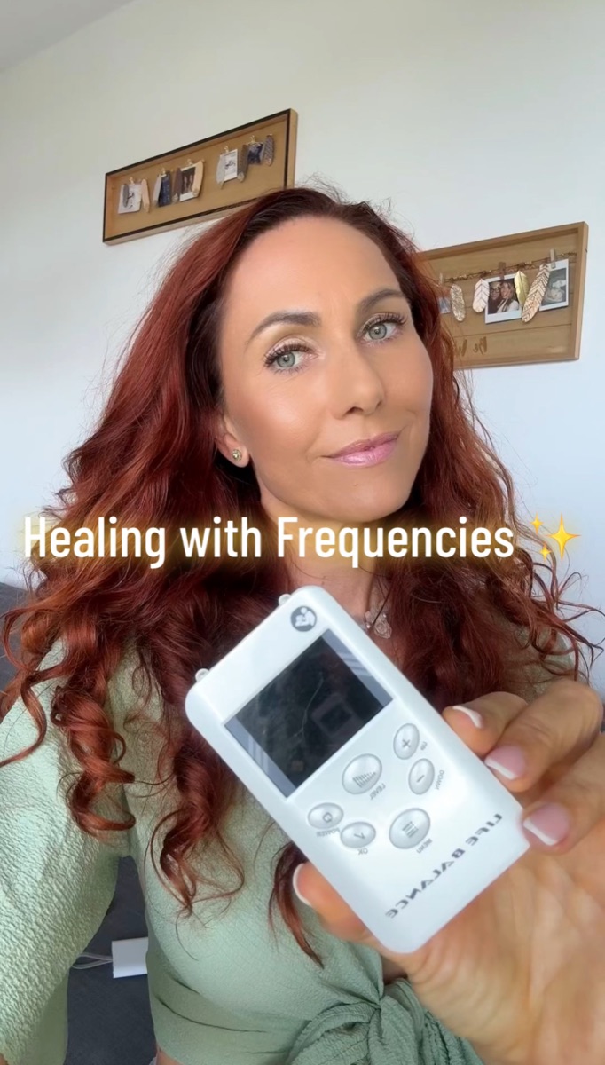 A portable Life Balance frequency device held in a hand